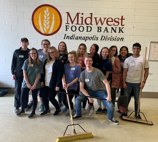 group of students in front of sign for Midwest food bank