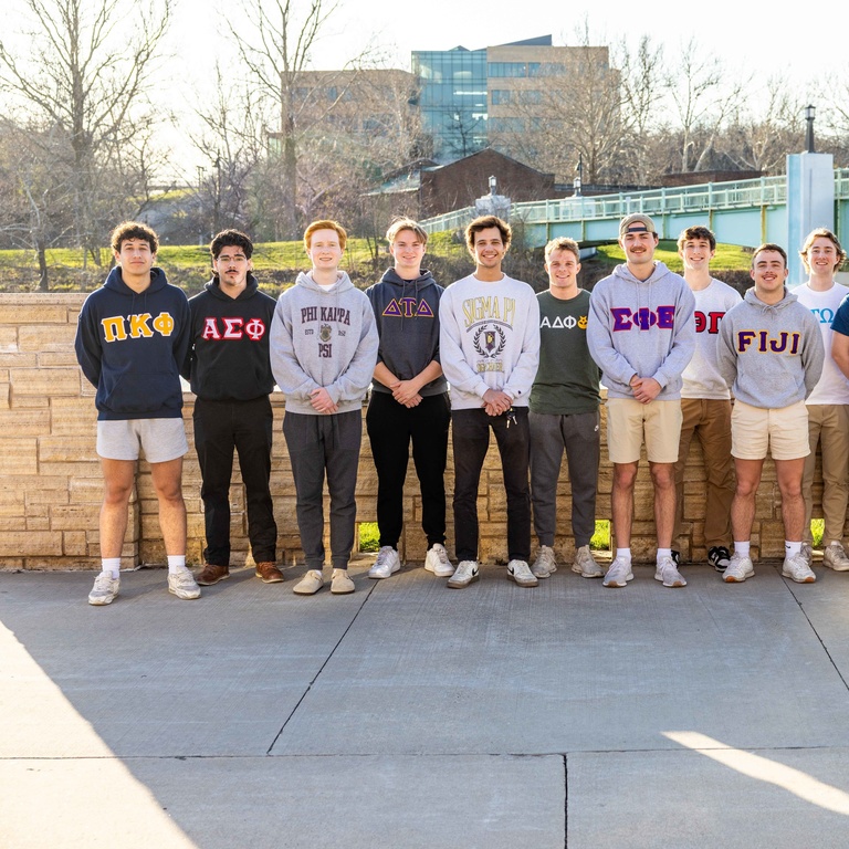 group of students standing outside on street
