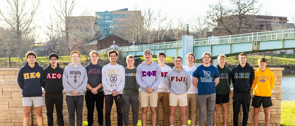 group of students standing outside on street